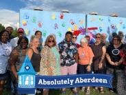 Volunteers and Supporters gather for the storm shelter murals dedication