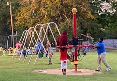 Children play before an outdoor movie at Newberger Park